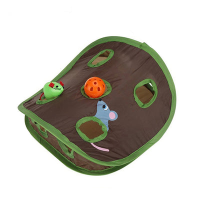 Grey tabby kitten playing with a brown and green hide-and-seek cat toy with multiple holes and a mouse graphic. - Image 5