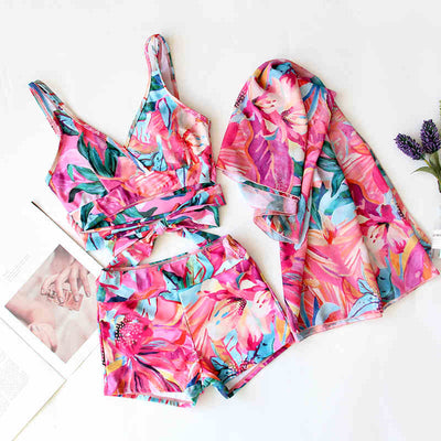 Women's three-piece swimwear set with a cream floral print, ruffled crop top, high-waisted shorts, and matching sarong. - Image 8