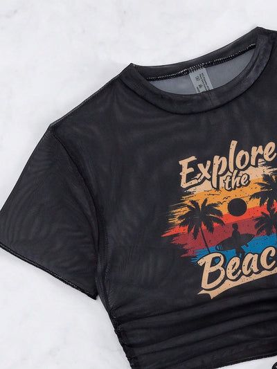 Black three-piece swimsuit with a mesh crop top featuring an "Explore the Beach" graphic, bikini top, and high-waisted bottoms. - Image 35
