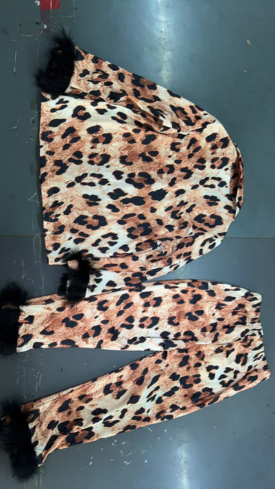 Young girl in a leopard print pajama set with black feather trim on the cuffs and ankles, wearing a pink glitter headband. - Image 29