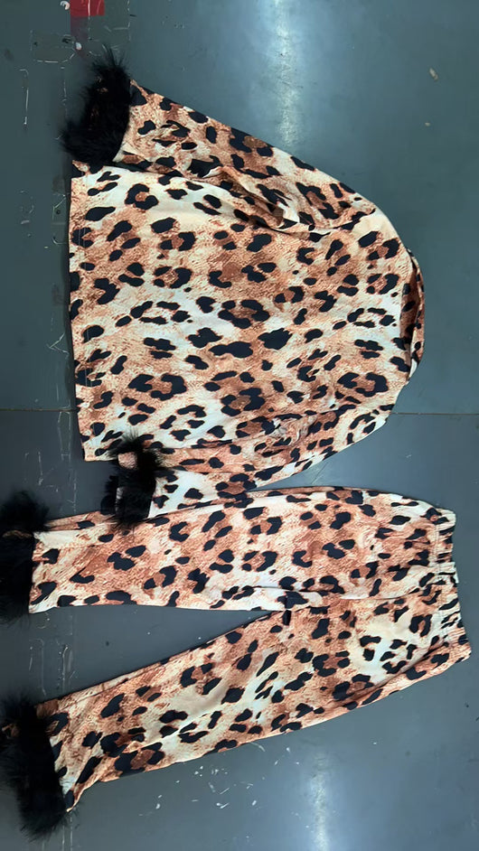 Young girl in a leopard print pajama set with black feather trim on the cuffs and ankles, wearing a pink glitter headband. - Image 29
