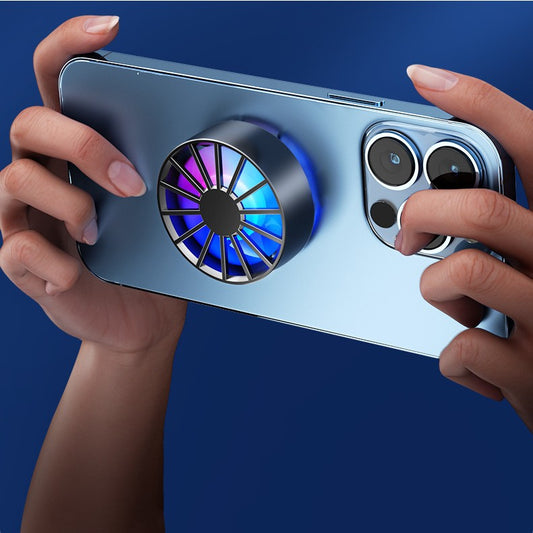 White magnetic phone cooler with blue and pink RGB lights, attached to a silver smartphone, against an icy blue background.