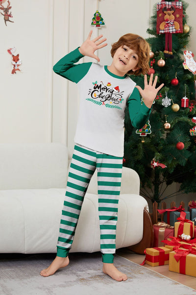 Family of four wearing matching green and white striped Christmas pajamas with "Merry Christmas" graphic. - Image 10
