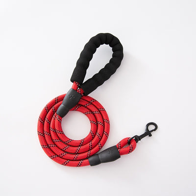 Red and black dog harness with reflective strips, adjustable straps, and a top handle for secure pet control. - Image 35
