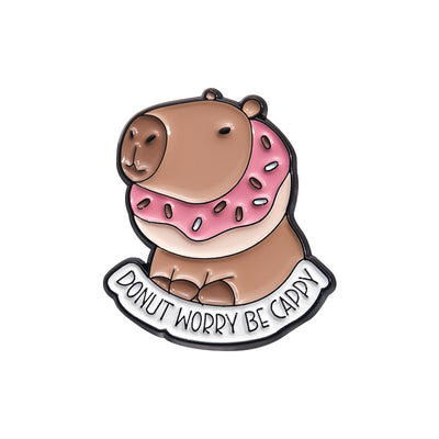 Cute capybara enamel brooch wearing a pink donut with sprinkles and "DONUT WORRY BE CAPPY" text. - Image 9
