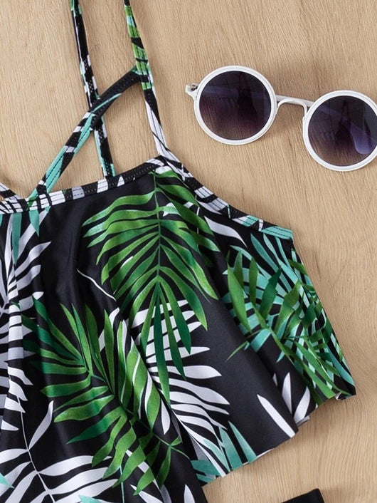 Women's split swimsuit with a black high-waisted bikini bottom and a flounced tankini top featuring a green, blue, and white tropical leaf print. - Image 25