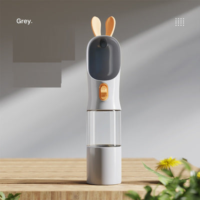 Grey and white portable pet water bottle with clear reservoir, built-in drinking bowl, and decorative bunny ears. - Image 8