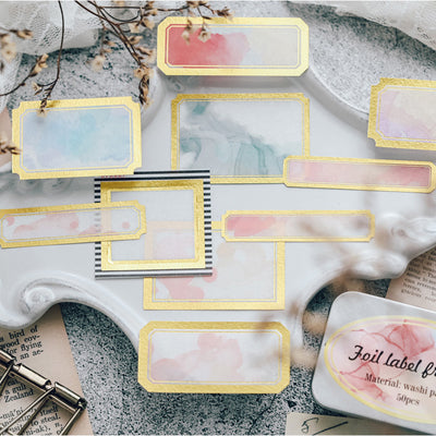 Assorted decorative paper labels with gold foil borders and soft watercolor designs in pink, blue, and green hues. - Image 3