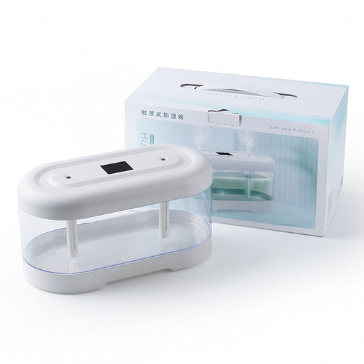 Dark green and clear oval USB humidifier with two mist outlets, shown next to its white product box. - Image 11
