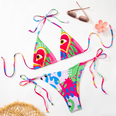 Women's vibrant abstract eye print bikini with triangle top and tie-side bottoms, featuring pink, green, and blue. - Image 8