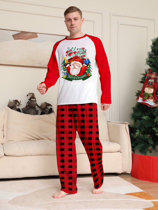 Man in a red and white Christmas pajama set with a Santa Claus graphic top and red and black plaid pants. - Image 8