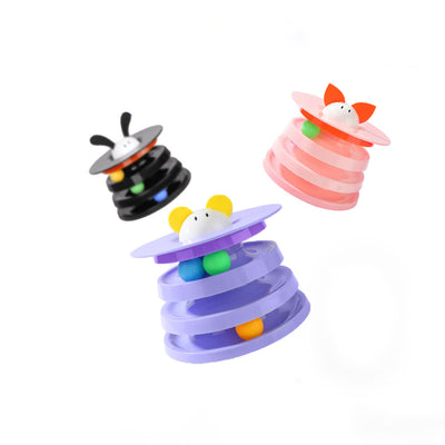 Brown tabby cat sniffing a black and orange multi-level rotating cat plate toy with colorful balls and bunny ears. - Image 6