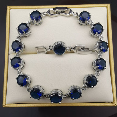 Four-piece silver-tone jewelry set with round green gemstones, including a necklace, bracelet, ring, and dangle earrings. - Image 18