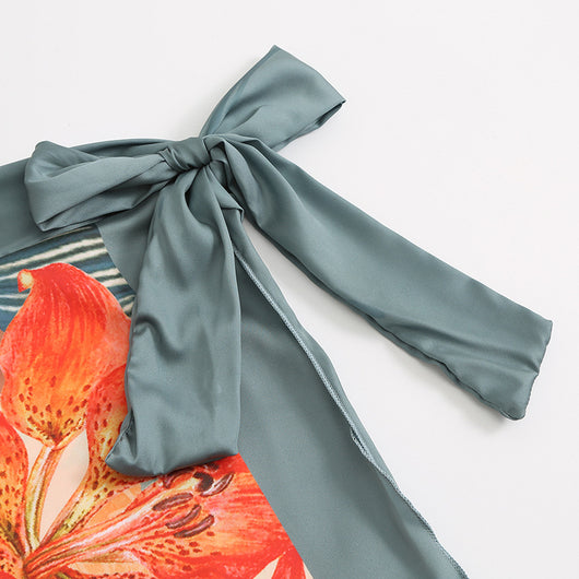 Two-piece tropical print swimsuit set with a V-neck one-piece and a matching long wrap skirt with tie waist. - Image 17