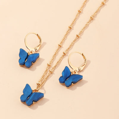 Blue resin butterfly necklace and earring set with gold-tone chains and findings, displayed on a light background. - Image 19