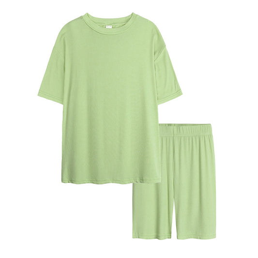 Pink ribbed short-sleeved t-shirt and biker shorts set for kids, ideal for summer casual wear or pajamas. - Image 2