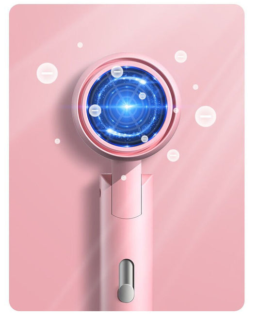 White portable folding hair dryer with rose gold accents and a nozzle attachment, shown with its base. - Image 12