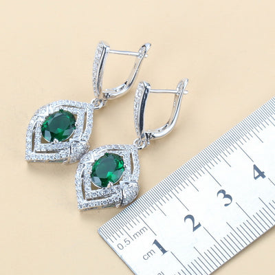 Silver-toned three-piece jewelry set with clear oval and round gems, including a necklace, dangle earrings, and a ring. - Image 17
