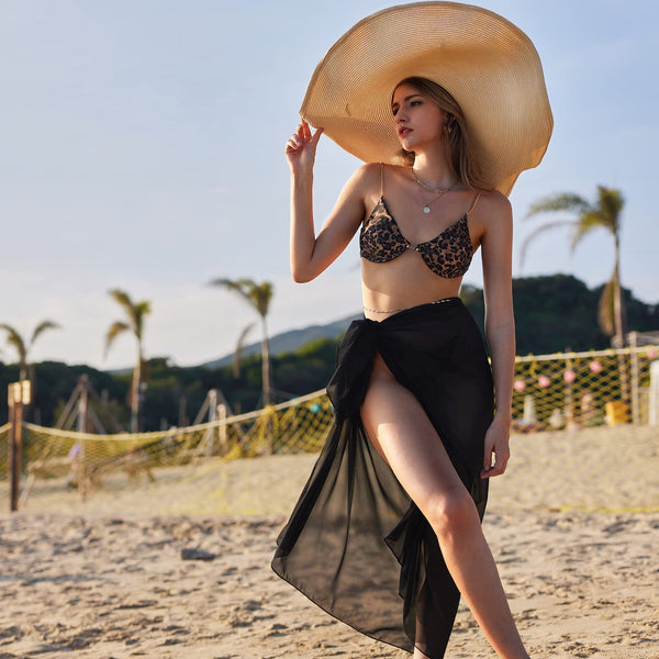 Women's navy blue chiffon sarong, long and flowing, draped over a model's arm against a white background.