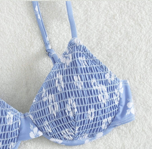 Periwinkle blue two-piece swimsuit with white floral pattern and ruched texture, featuring an underwire bikini top and high-cut bottoms. - Image 17