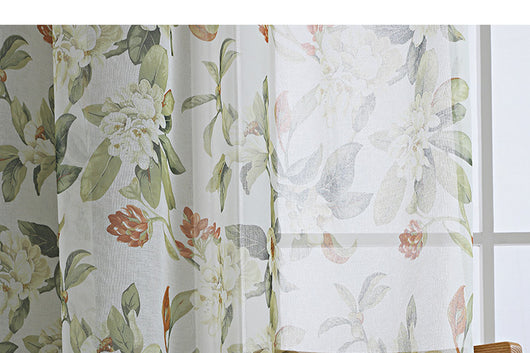 Dark gray semi-sheer curtains with a white and green floral pattern, hung on a black rod in a living room. - Image 10