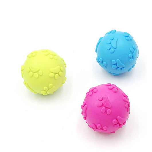 Bright pink TPR dog toy ball with raised paw print and oval patterns, designed for chewing and play. - Image 3