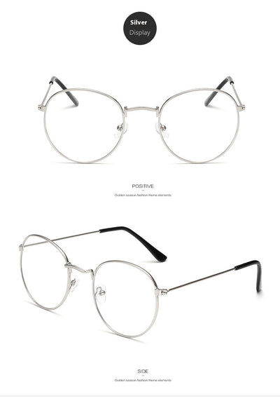 Retro oval anti-blue light glasses with a dark metal frame and clear lenses on a white background. - Image 17