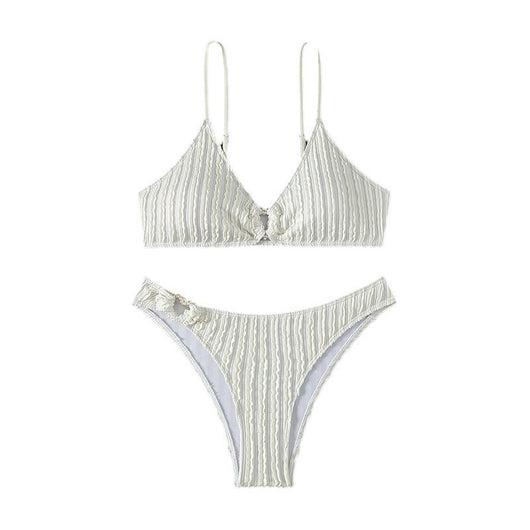 Women's white ribbed V-neck bikini with a front tie top and side ring bottoms, modeled by the ocean. - Image 5