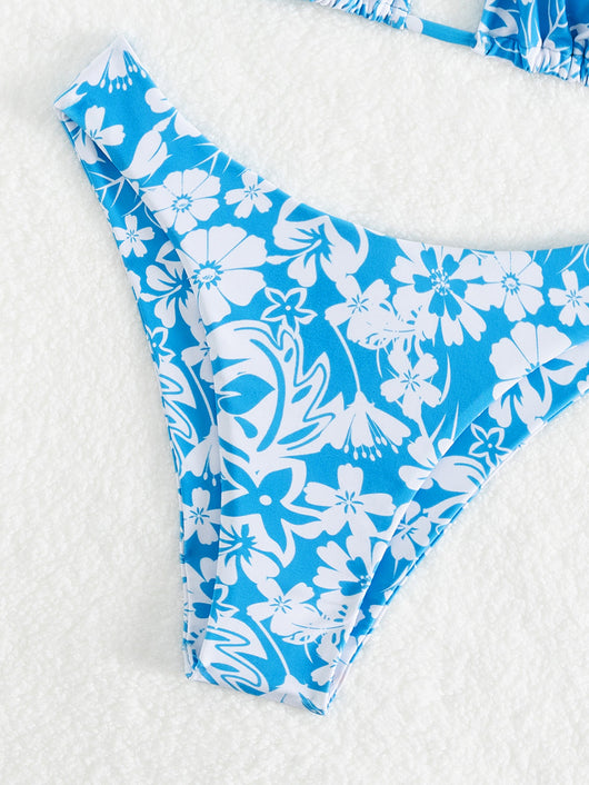 Woman wearing a black and white floral print triangle cup bikini swimsuit on a sunny beach. - Image 13