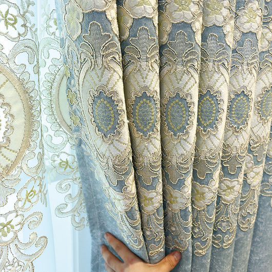 Blue sheer curtain with intricate gold and dark blue embroidery in a European classical style, draped over a window. - Image 2
