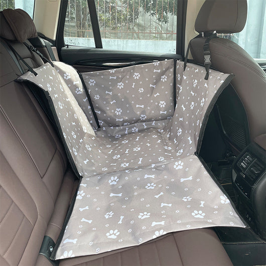 Brown pet car mat with colorful dog pattern installed in a car's rear seat, protecting upholstery. - Image 12