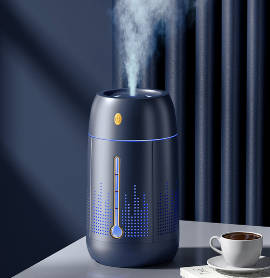 White cylindrical household humidifier with a visible water level indicator, next to its brown cardboard packaging. - Image 11