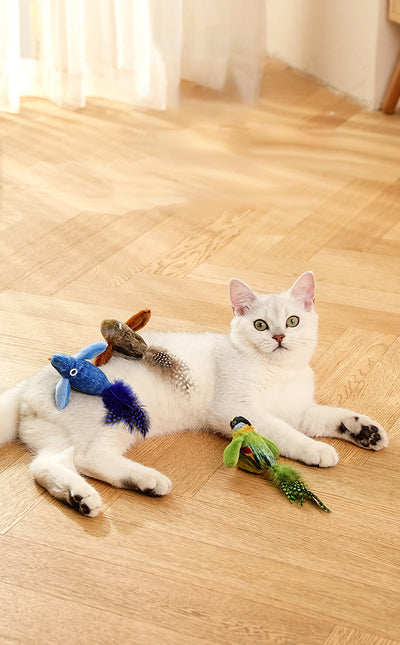 Colorful bird cat toy with green fluffy wings, black head, yellow face, orange beak, and spotted tail feathers. - Image 29