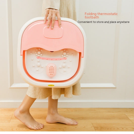 Gray and white collapsible foot spa basin with heating function, massage nubs, and a partial lid.