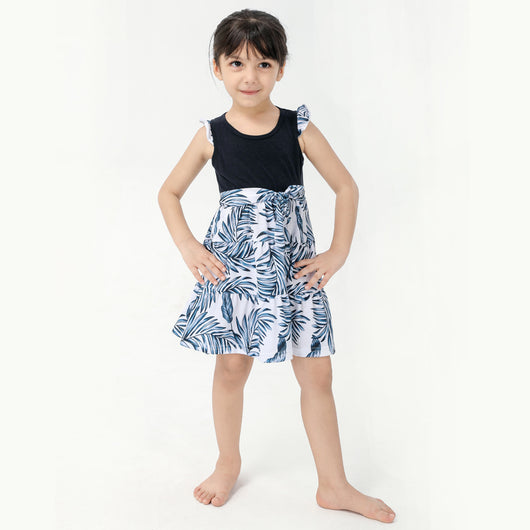 Young boy wearing a white short-sleeve t-shirt with blue tropical leaf print and a black chest pocket. - Image 13