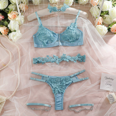 Light blue lace lingerie set with floral details, including a bra, thong, garter belt, choker, and leg chains. - Image 19