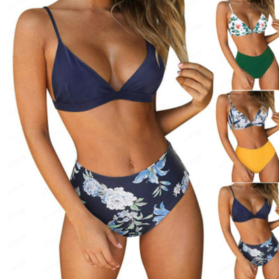 Navy blue bikini with a solid triangle top and high-waisted bottoms featuring a white and blue floral print.