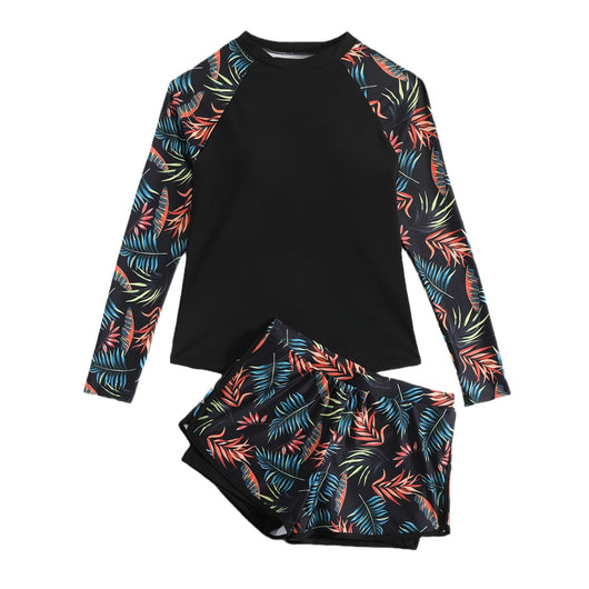 Women's long-sleeve tankini swimsuit with black top and blue tropical leaf print raglan sleeves, matching swim shorts. - Image 5