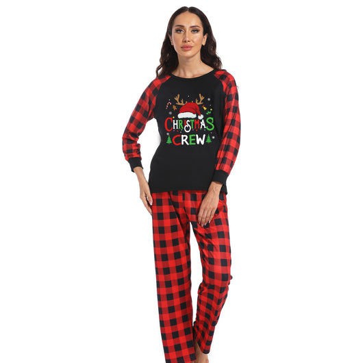 Man wearing a Christmas pajama set with a black long-sleeve top and red and black buffalo plaid pants. - Image 6