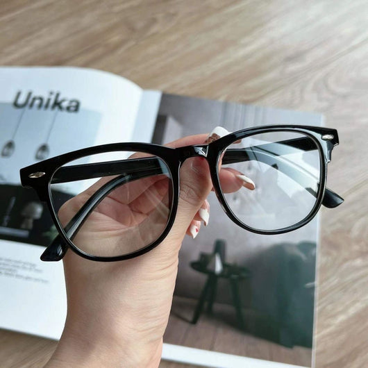 Retro square transparent full-frame glasses with blue light lenses, held by a person wearing grey sweatpants. - Image 5