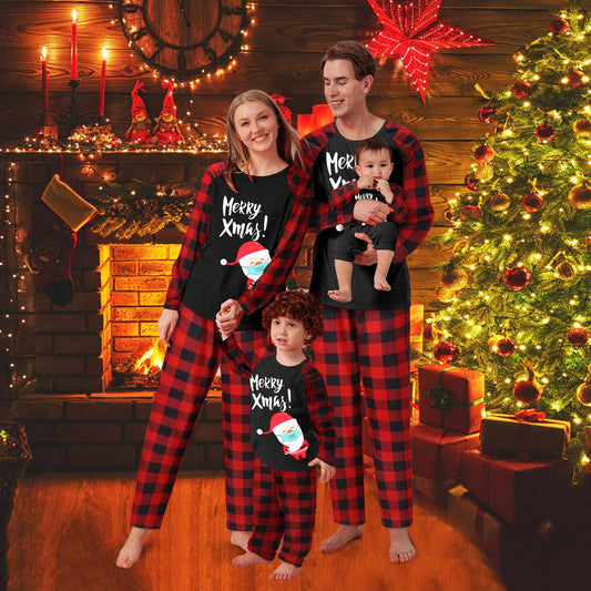 Family matching Christmas pajamas with black tops, red plaid sleeves, and Santa wearing a mask, paired with red plaid pants.