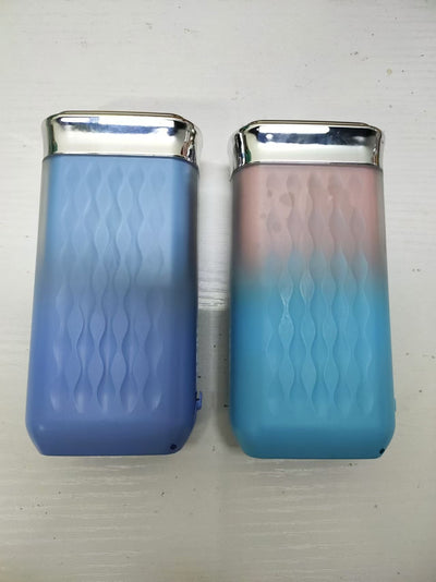 Portable water flosser in gradient pink and blue with four nozzles, a charging cable, and its product box. - Image 15