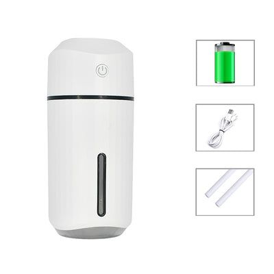 Pink portable humidifier with a power button, water level indicator, USB charging cable, and two cotton swabs. - Image 8