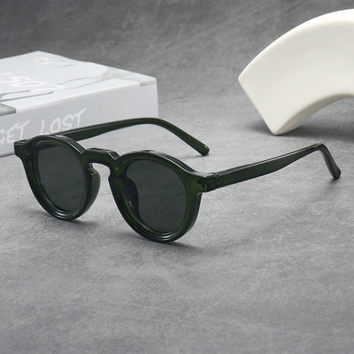 Vintage round frame sunglasses with black frames and pink lenses on a gray surface. - Image 13