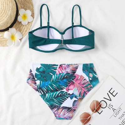 Teal twisted bandeau bikini top with tropical leaf print high-waisted bottoms on a model wearing a white shirt. - Image 16