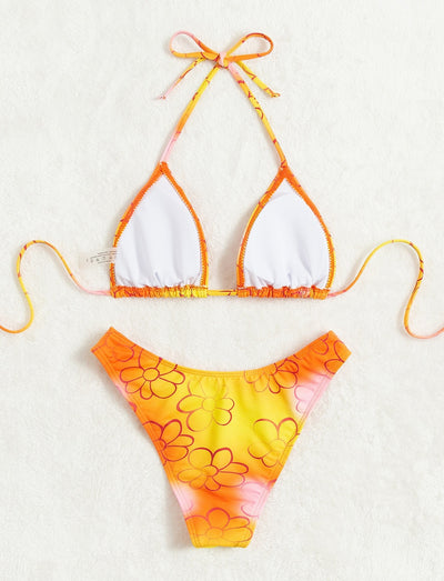 Yellow and orange floral string bikini swimsuit for women, featuring a triangle top and high-cut bottoms by a pool. - Image 12