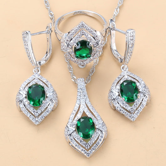 Silver-toned three-piece jewelry set with clear oval and round gems, including a necklace, dangle earrings, and a ring. - Image 6