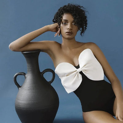 Black one-piece swimsuit with a white oversized bow detail at the tube top bust, perfect for summer. - Image 3