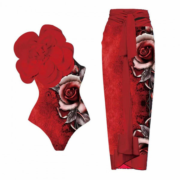 Red sarong-style maxi skirt with a large, detailed rose print on one side and a tie-waist closure.