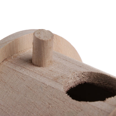 Wooden outdoor bird nest with a conical striped roof and a small entrance hole, next to a bird on a branch. - Image 10